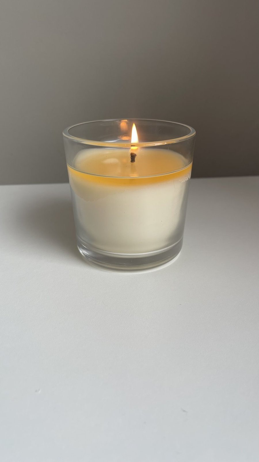 Handmade container candle in a clear glass jar